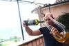 Aleš Kristančič med dekantiranjem lunarja chardonnay - vina, ki ga po 9 mesecih zorenja, ob polni luni, pretočijo v steklenice, brez dodajanja žvepla, brez filtracije in brez prešanja. Foto: MMC RTV SLO