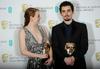 Emma Stone in Damien Chazelle sta še dodatno obogatila svoji vitrini 'trofej' za Deželo La La. Foto: Reuters