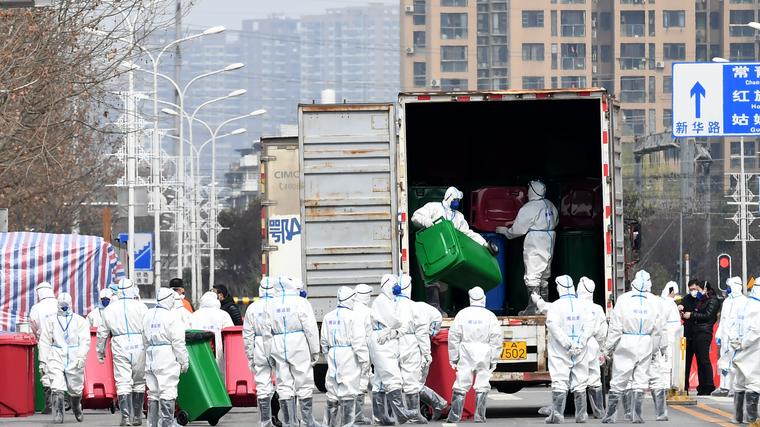 Delavci v zaščitnih oblekah čustijo ribjo tržnico in tržnico z divjimi živalmi Huanan v Vuhanu, kjer naj bi domnevno prišlo do prvih primerov okužbe s SARS-CoV-2. Foto: Reuters