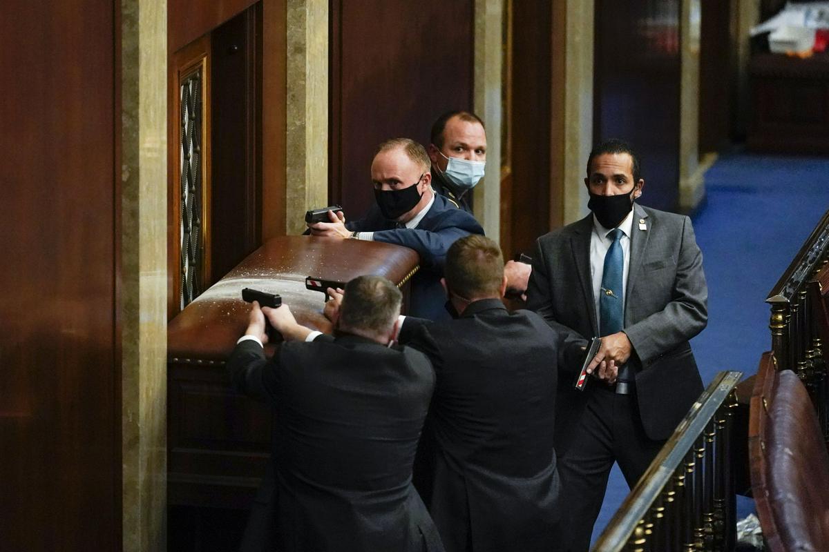 Protestniki so razbili okno zgradbe. V notranjosti pa je bilo tistih nekaj malo varnostnikov v pripravljenosti. Foto: AP Protestniki so razbili okno zgradbe. V notranjosti pa je bilo tistih nekaj malo varnostnikov v pripravljenosti. Foto: AP